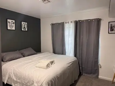 a dog laying on a bed in a bedroom at Large 2Kings 2 bedroom 2 bath by EWR NYC Downtown Newark in Newark