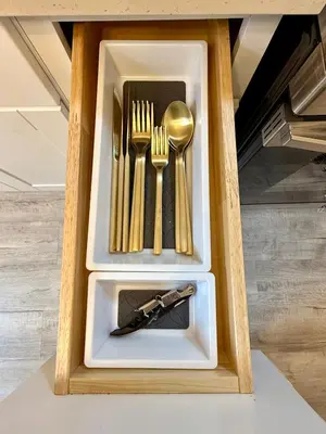 a wooden box with forks and spoons and a knife at Renovated private urban flat - 20 min to Manhattan NYC in Jersey City