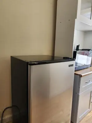 a stainless steel refrigerator in a kitchen at Luxury Vibes ,Cozy Location in East Orange