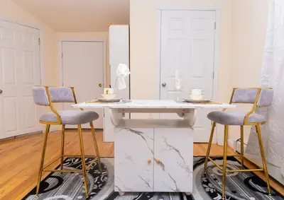 a kitchen with a white counter and two stools at Luxury Vibes ,Cozy Location in East Orange