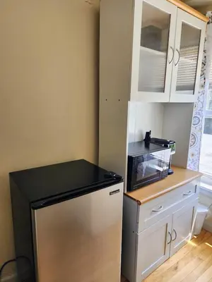 a small kitchen with a refrigerator and a counter at Luxury Vibes ,Cozy Location in East Orange