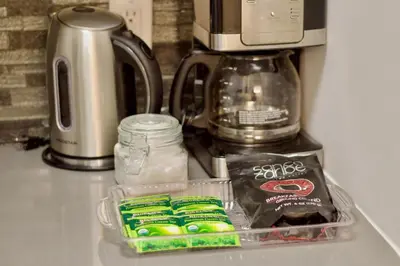 a counter top with a container of food and a microwave at Stay In Times Square! 2-Bedroom Apartments in New York