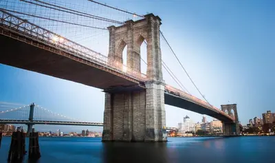 a bridge over the water with a city in the background at Stylish 2 BD Apt-18 mins from NYC-Steps away Bus stop, Restaurants, Groceries in Jersey City