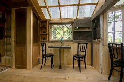 a room with a table and chairs and a window at The Outlier Inn in Woodridge