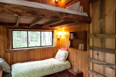 a bedroom with a bunk bed in a cabin at The Outlier Inn in Woodridge