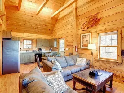 a living room with a couch and a table in a cabin at Haven View Retreat in White Haven