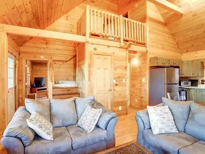 a living room with a couch in a log cabin at Haven View Retreat in White Haven