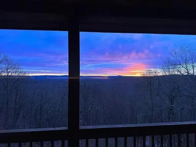 a view of a sunset from a house window at Haven View Retreat in White Haven