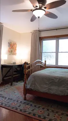 a bedroom with a bed and a ceiling fan at Cammalot - Pine Creek Valley