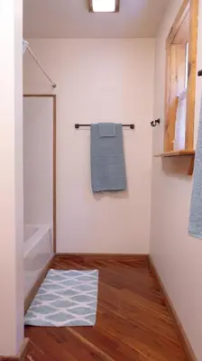 a bathroom with a towel rack and a blue rug at Cammalot - Pine Creek Valley