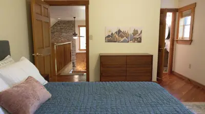 a bedroom with a bed and a dresser and a hallway at Cammalot - Pine Creek Valley