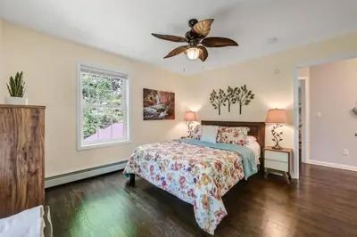 a bedroom with a bed and a ceiling fan at Zen Lake House in Greenwood Lake