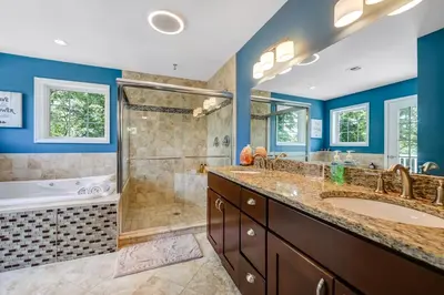 a bathroom with two sinks and a shower at Zen Lake House in Greenwood Lake