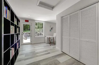 a hallway with a sliding garage door and a table at Zen Lake House in Greenwood Lake