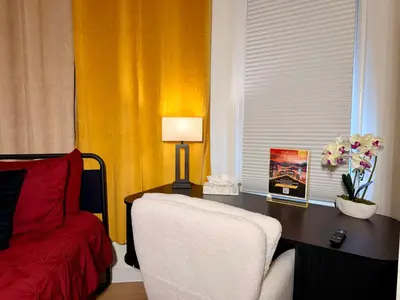 a bedroom with a desk with a chair and a lamp at BP STAYS - Hotel-Style, No Host, Professionally Managed ID247 in Jersey City