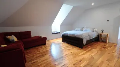 a living room with a bed and a couch at Carpathia West Estate in West Milford