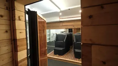 a room with two computers in a room with wooden walls at Carpathia West Estate in West Milford
