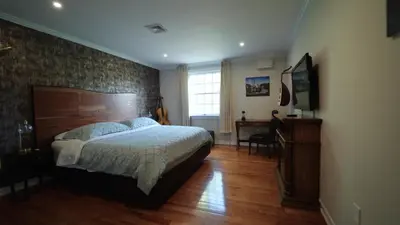 a bedroom with a large bed and a desk at Carpathia West Estate in West Milford