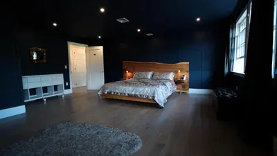 a bedroom with a bed in a dark room at Carpathia West Estate in West Milford