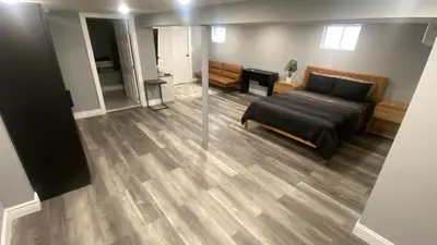 a bedroom with a bed and a living room at Fantastic Studio in North Bergen