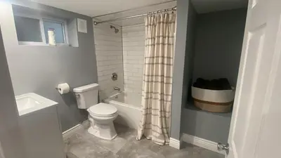 a bathroom with a toilet and a shower curtain at Fantastic Studio in North Bergen