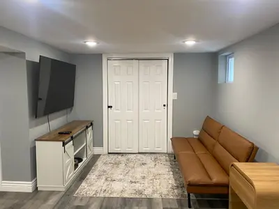 a living room with a couch and a flat screen tv at Fantastic Studio in North Bergen