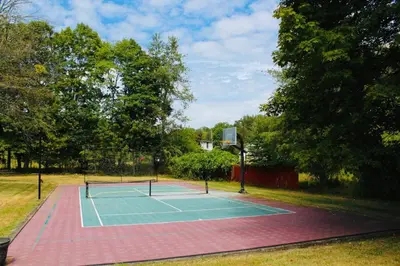 a tennis court with two tennis rackets on it at Pocono Ridge Inn East Stroudsburg - Poconos in East Stroudsburg