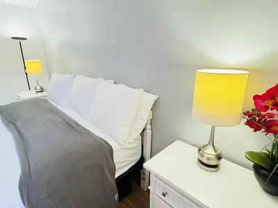 a bedroom with a bed and a lamp on a table at Pocono Ridge Inn East Stroudsburg - Poconos in East Stroudsburg