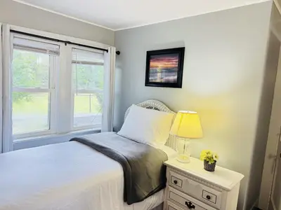 a bedroom with a bed with a lamp and a window at Pocono Ridge Inn East Stroudsburg - Poconos in East Stroudsburg
