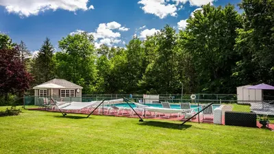 a swimming pool with a slide in a yard at Pocono Ridge Inn East Stroudsburg - Poconos in East Stroudsburg
