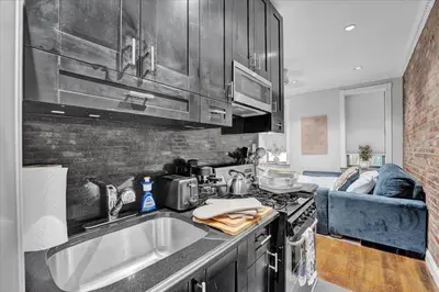 a kitchen with a sink and a stove at Stylish 3BR-2BA in Gramercy in New York