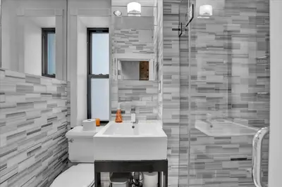 a bathroom with a white sink and a shower at Stylish 3BR-2BA in Gramercy in New York