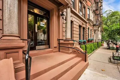 a building with a set of stairs leading to a door at Stylish 3BR-2BA in Gramercy in New York