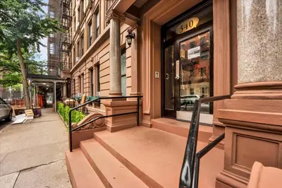 a door to a store on a city street at Stylish 3BR-2BA in Gramercy in New York