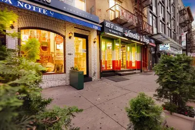a street with shops on a city street at SoHo Designer 2BR w balcony in New York