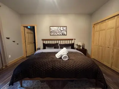a bedroom with a bed with two towels on it at Luxe Modern Cabin with Pond, Fire Pit, Hiking, near Bethel Woods in Narrowsburg