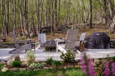 a group of chairs and a table in a garden at Fire Pit, Private & Stylish Birdsong Schoolhouse in Barryville