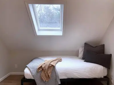a bed in a room with a window at Lake House, Fire Pit, Games Magnolia Lake House in Ferndale