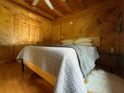 a bedroom with a bed in a wooden cabin at Red Tail Ridge in North Branch