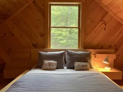 a bed with two pillows in a room with a window at Red Tail Ridge in North Branch