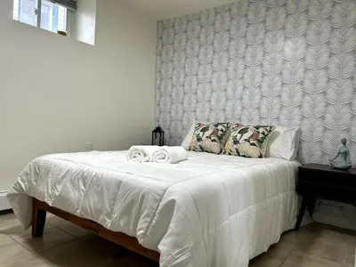 a bedroom with a white bed with towels on it at Cozy 1 Bedroom Apt - Minutes to NYC - Great for Remote Work in North Bergen