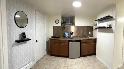 a kitchen with a sink and a refrigerator at Cozy 1 Bedroom Apt - Minutes to NYC - Great for Remote Work in North Bergen