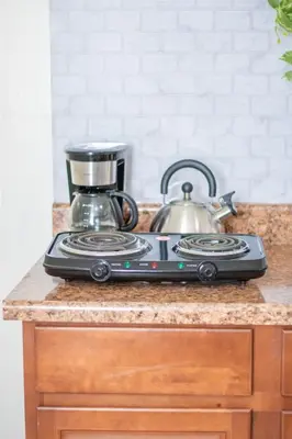 a stove top with a tea pot on a counter at Cozy 1 Bedroom Apt - Minutes to NYC - Great for Remote Work in North Bergen