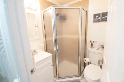 a bathroom with a shower and a toilet at Cozy 1 Bedroom Apt - Minutes to NYC - Great for Remote Work in North Bergen