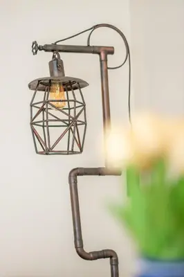 a metal light fixture hanging from a wall at Cozy 1 Bedroom Apt - Minutes to NYC - Great for Remote Work in North Bergen