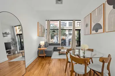 a living room with a table and a couch at Stylish Manhattan Escape in Prime Spot in New York