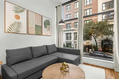 a living room with a couch and a table at Stylish Manhattan Escape in Prime Spot in New York