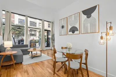 a living room with a table and a couch at Stylish Manhattan Escape in Prime Spot in New York