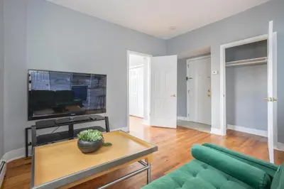 a living room with a couch and a tv at One BR near Metlife with Laundry & Parking in Lodi