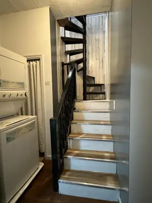 a spiral staircase in a kitchen with a refrigerator at New York Skyline One of a Kind View in Union City